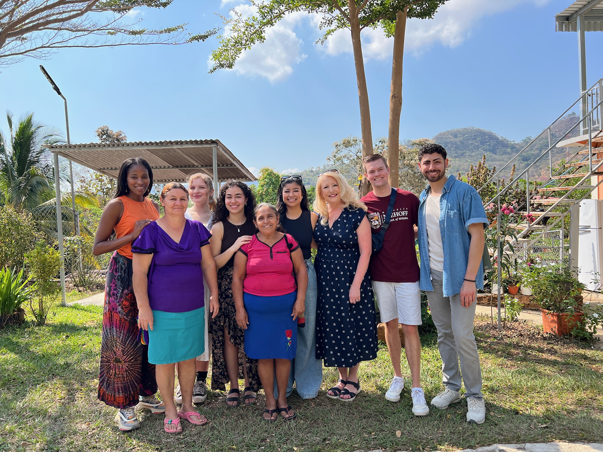 ABSN students and staff pose for a picture with community members in El Salvador