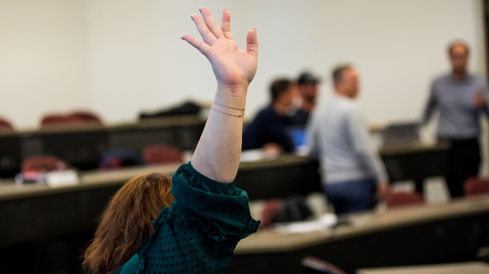 A student raises their hand in class.