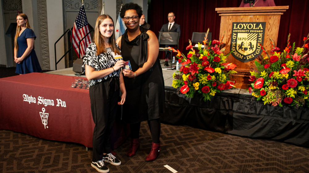 A School of Education student is inducted into the Alpha Sigma Nu Honor Society.