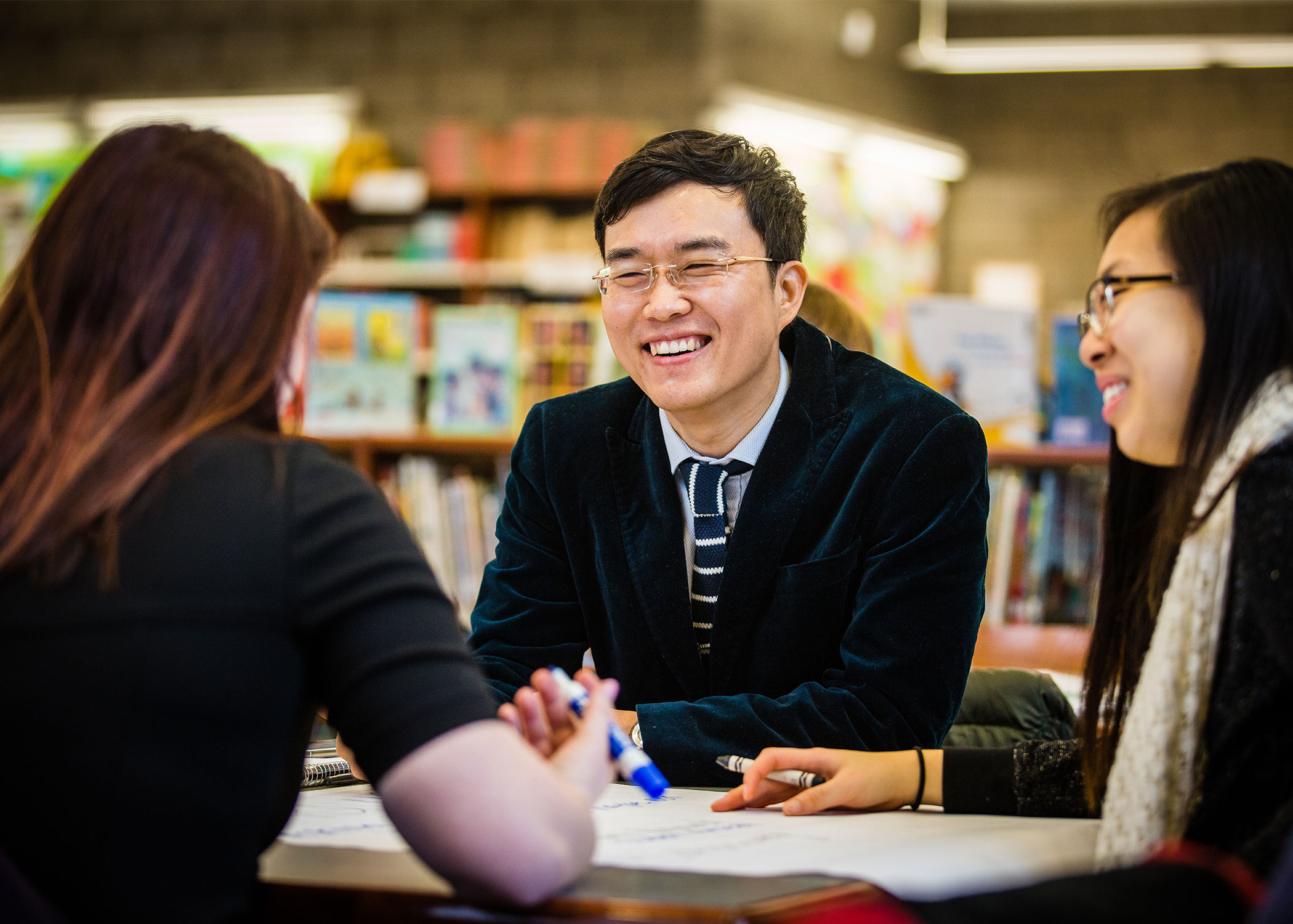 Professor Seungho Moon sits with School of Education teacher candidates