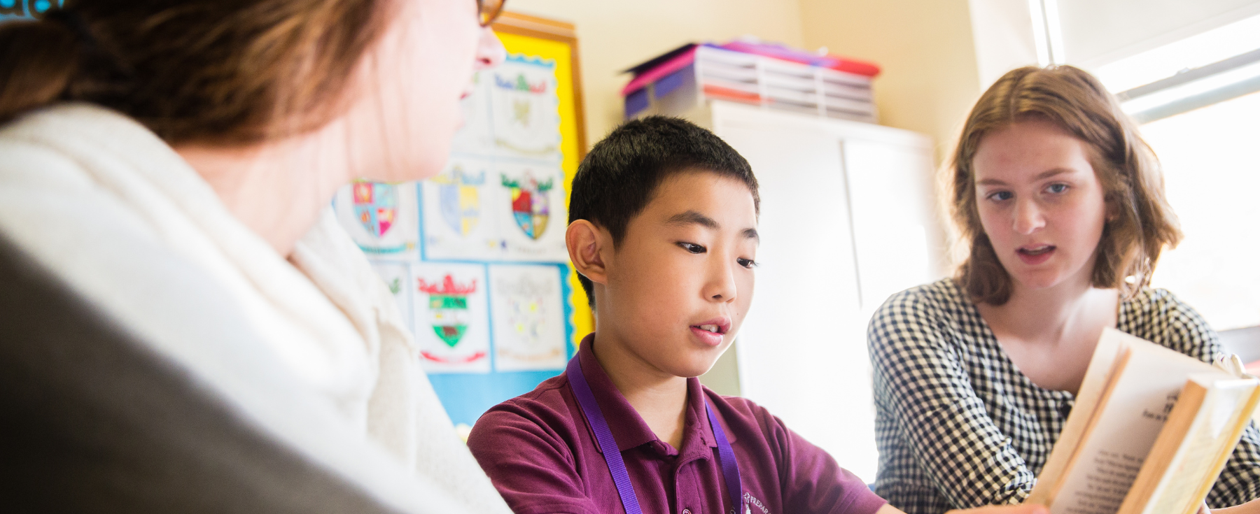 A student receiving help from teachers.