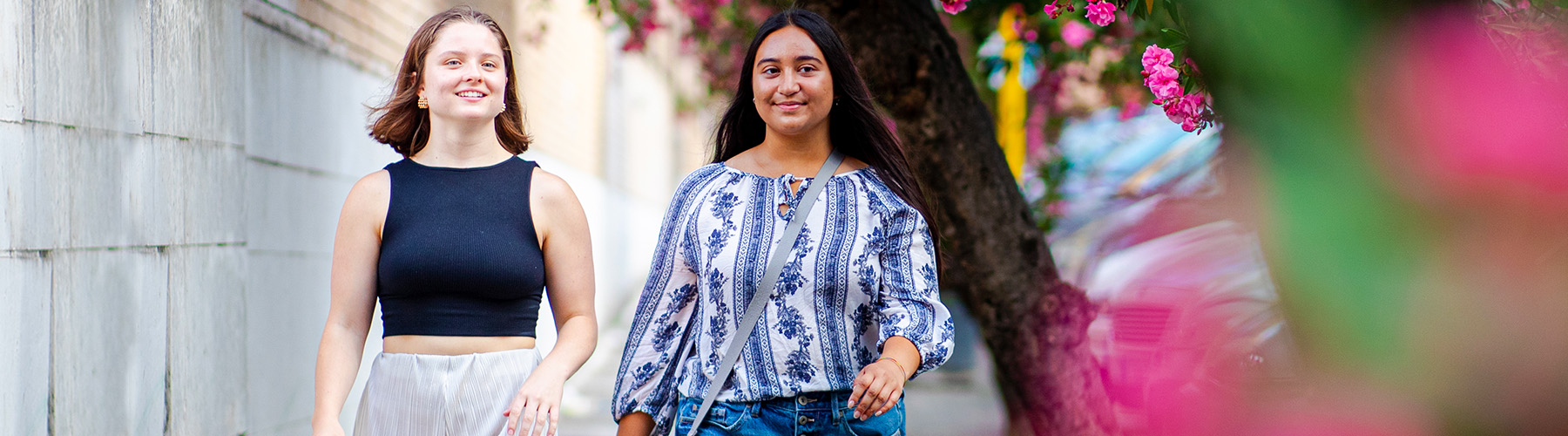 Two students enjoy the flowery scenery of Rome