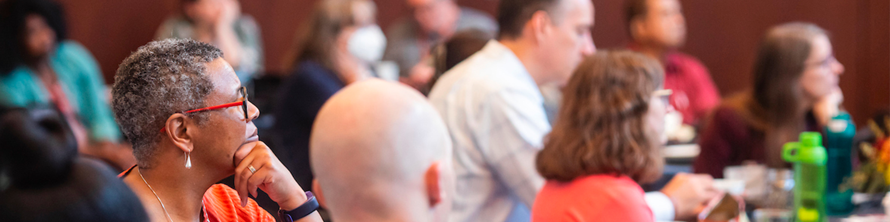 Participators in a DEI kickoff event listen to a speaker