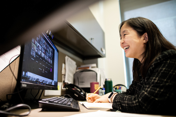 woman at computer attending a zoom meeting