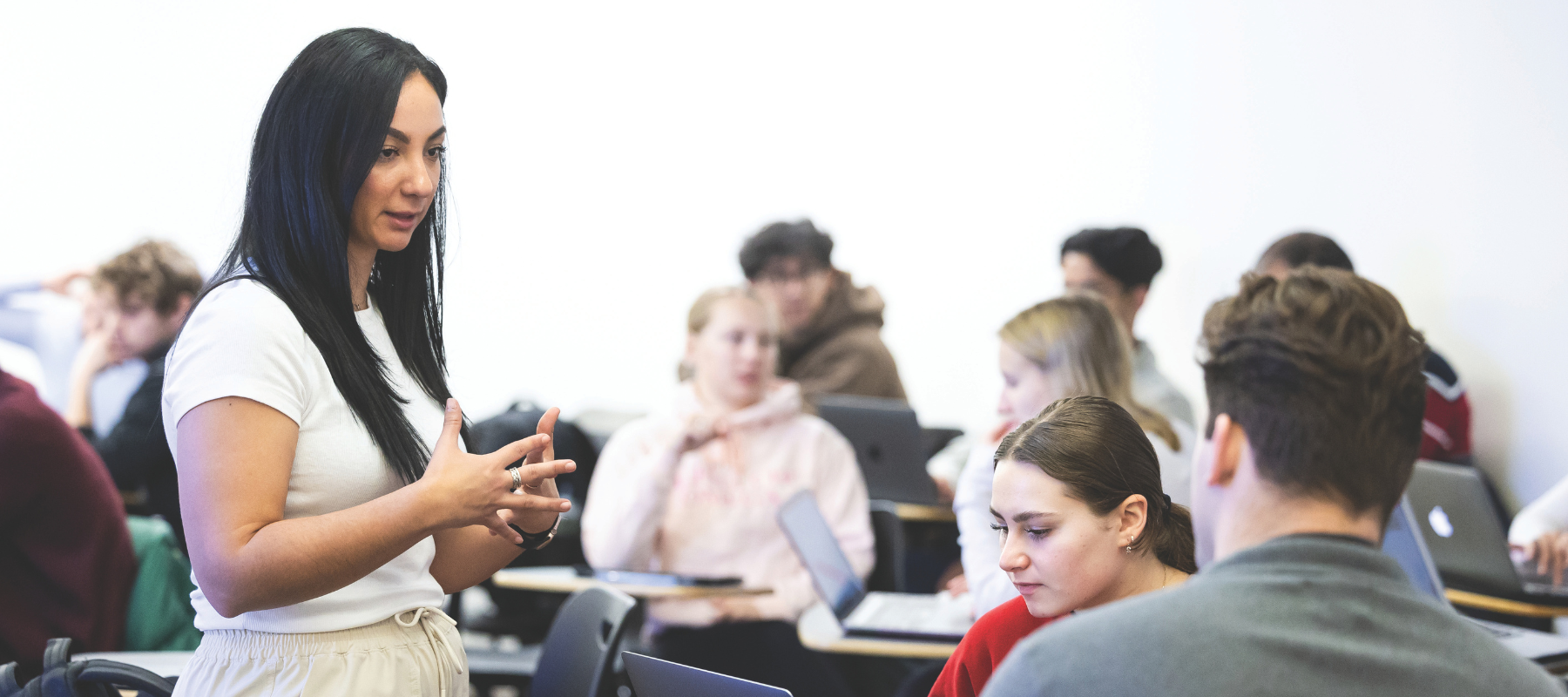 Instructor talking to student in class.