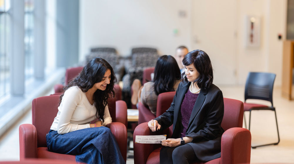 Career Services staff Edith Sanchez-Saenz works with Quinlan student Hiba Rizvi on reviewing career resources.