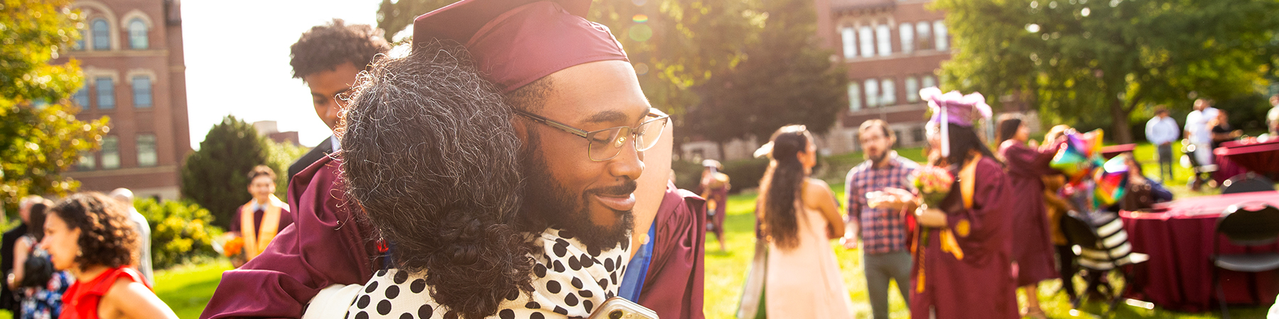 Loyola student hugs a loved one during commencement