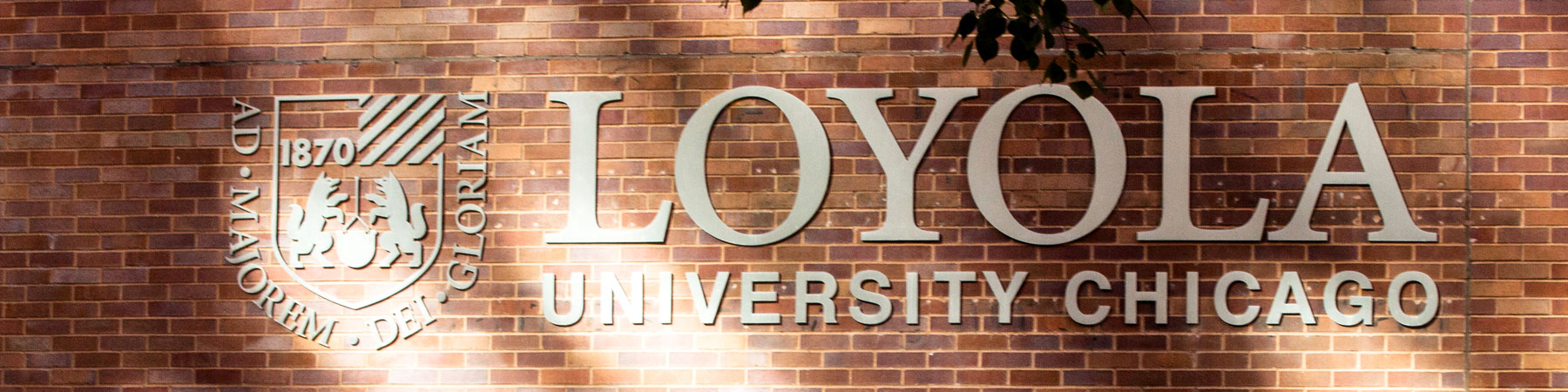 Loyola University logo metal signage on a brick wall