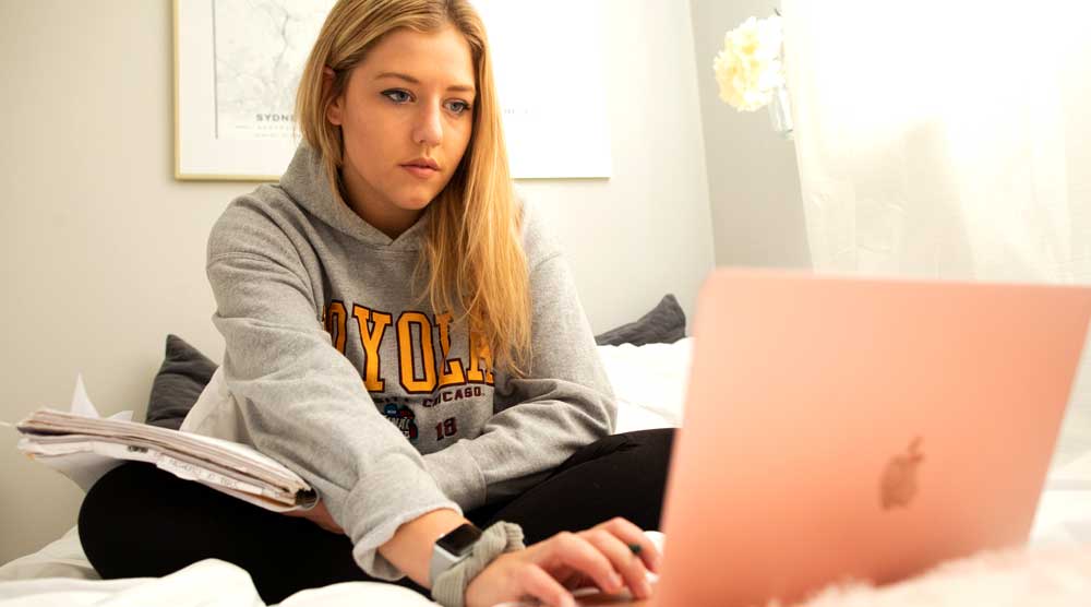 Loyola University Chicago student studies in her dorm