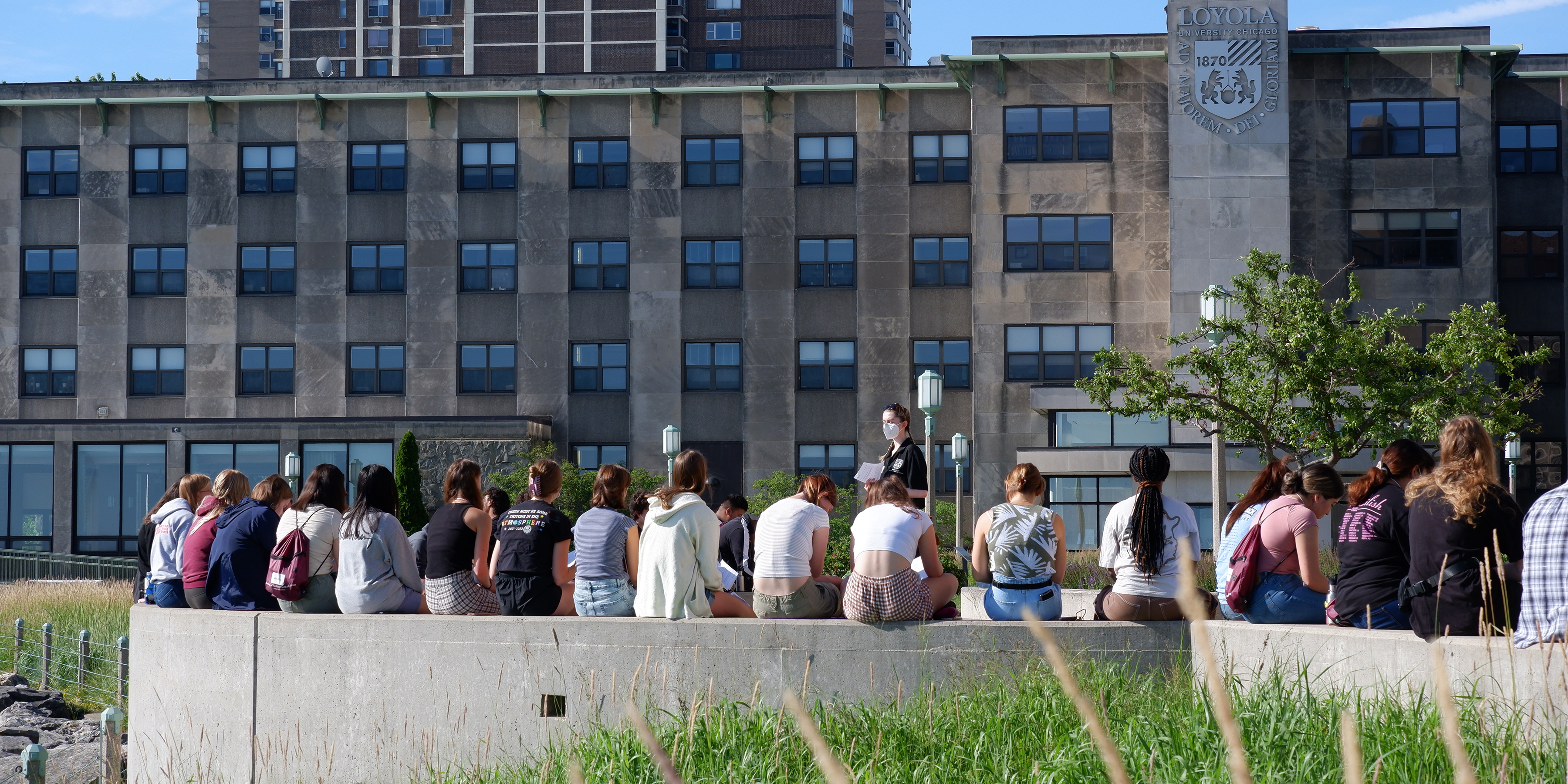 THEA Institute Students sitting outside on campus