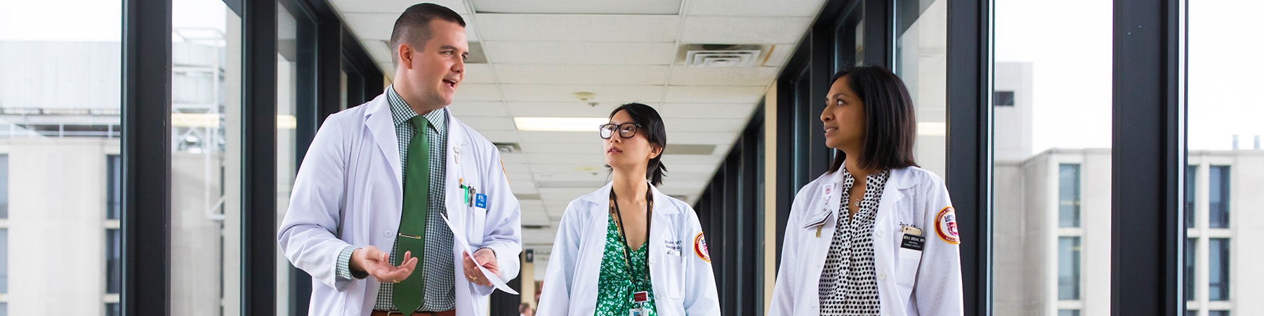 President's Medallion Award Winner Dr. Bill Flavin (left) talks with colleagues Dr. Christina Ding and Dr. Bina Desai at Stritch Medical Center