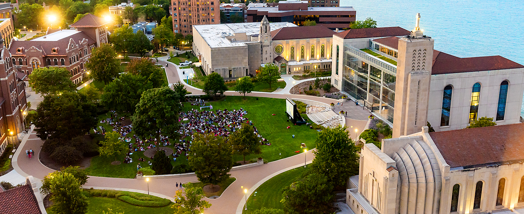 An aerial perspective of the east quad on the Lake Shore Campus of Loyola University Chicago during the golden hour of the day.